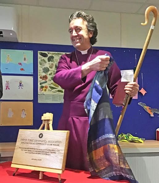 The Bishop of Ramsbury beside the engraved plaque marking the opening of the Chilton Foliat Community Club House in January 2020